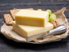 Block of aged cheddar cheese, the most popular type of cheese in United Kingdom and USA, natural cheese made from cow milk Block of aged cheddar cheese, the most popular type of cheese in United Kingdom and USA, natural cheese made from cow milk